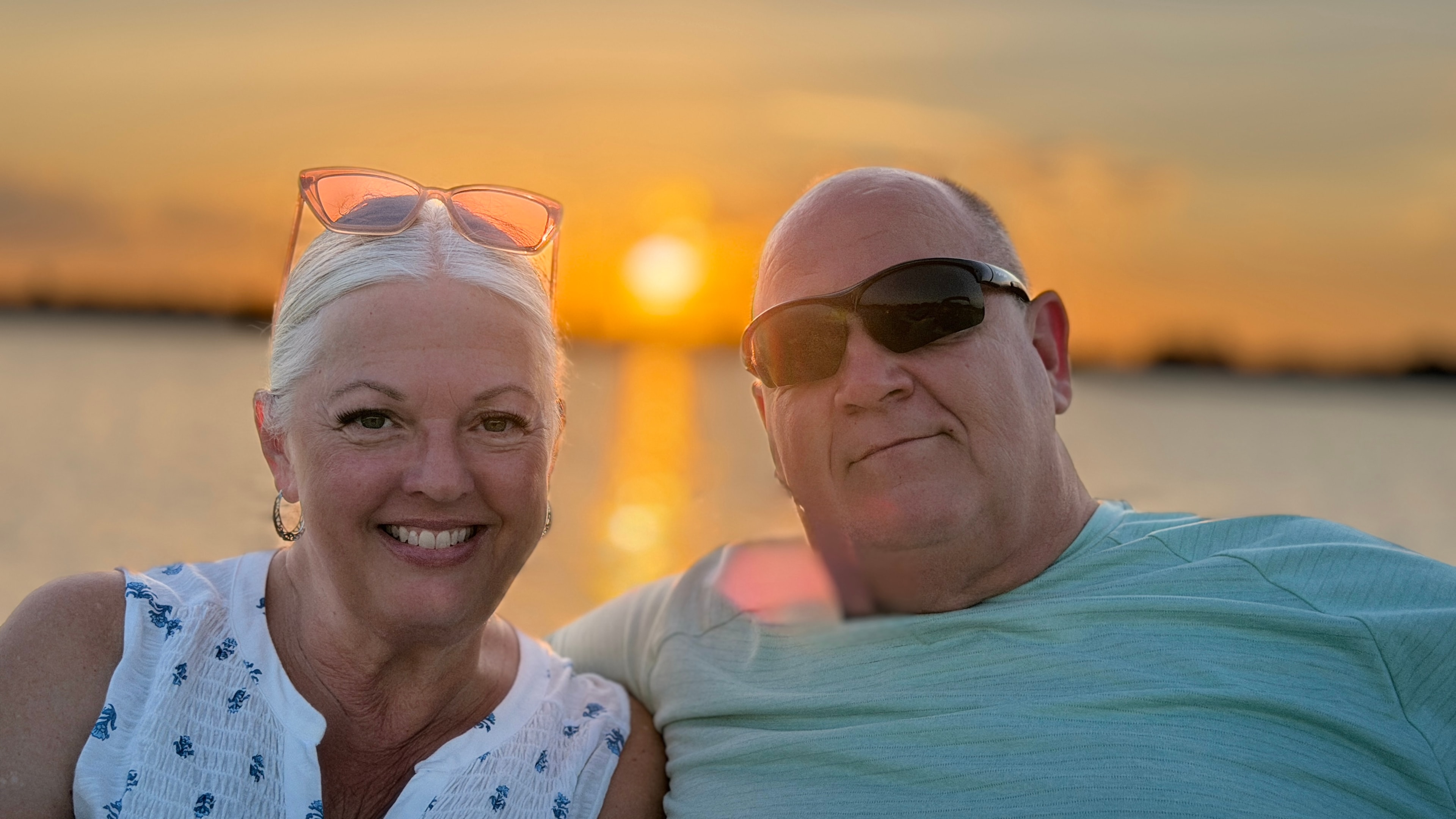 Couple smiling together at sunset on a Daytona Beach boat cruise